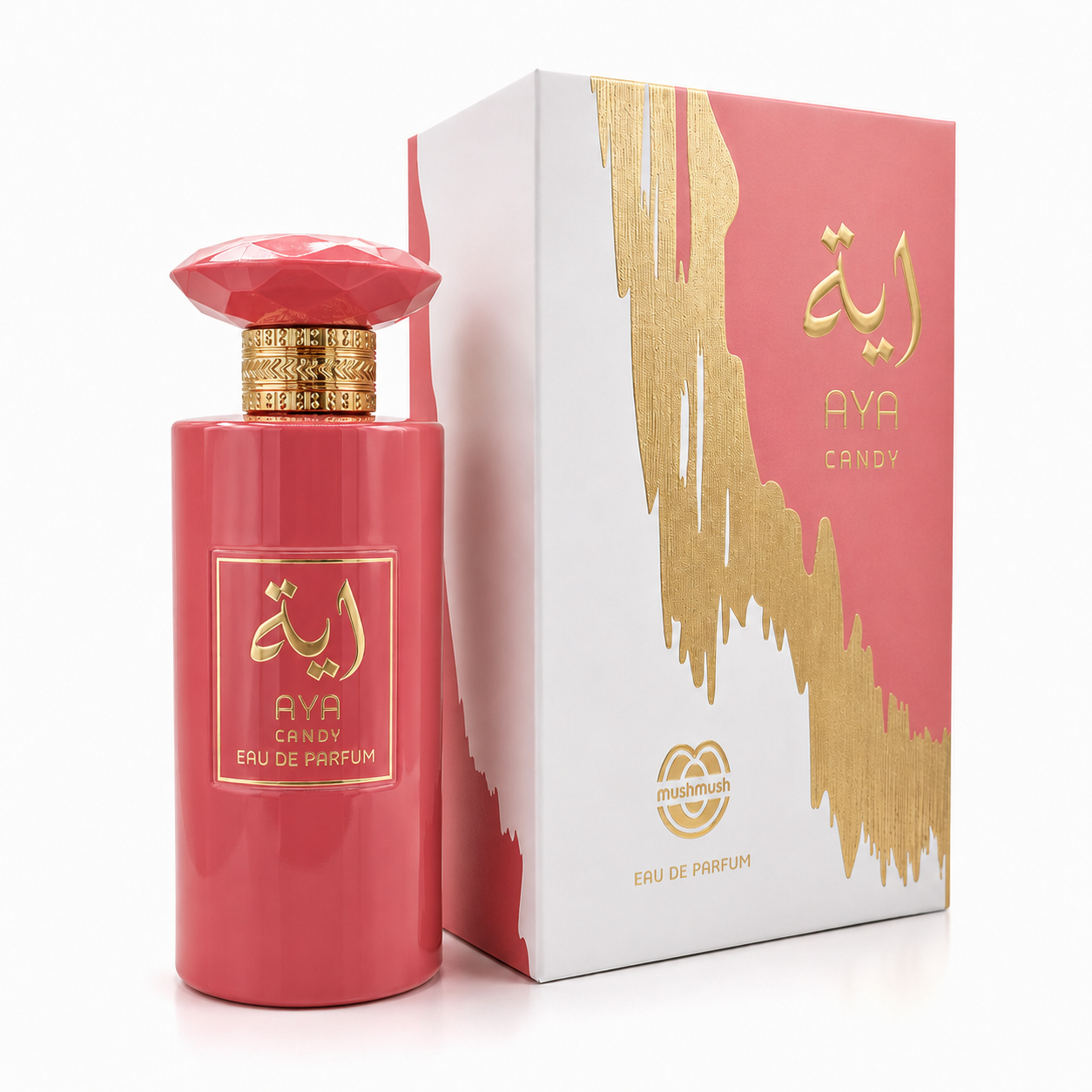 AYA CANDY Eau de Parfum bright coral pink bottle with gold accents, standing next to its matching white and coral pink presentation box decorated with metallic gold paint-drip artwork and Arabic calligraphy.