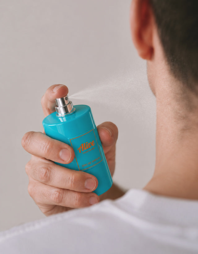 MUSHMUSH Alive Pour Homme Eau de Parfum, long-lasting men’s fragrance for daily wear, shown being sprayed as a modern affordable luxury scent.