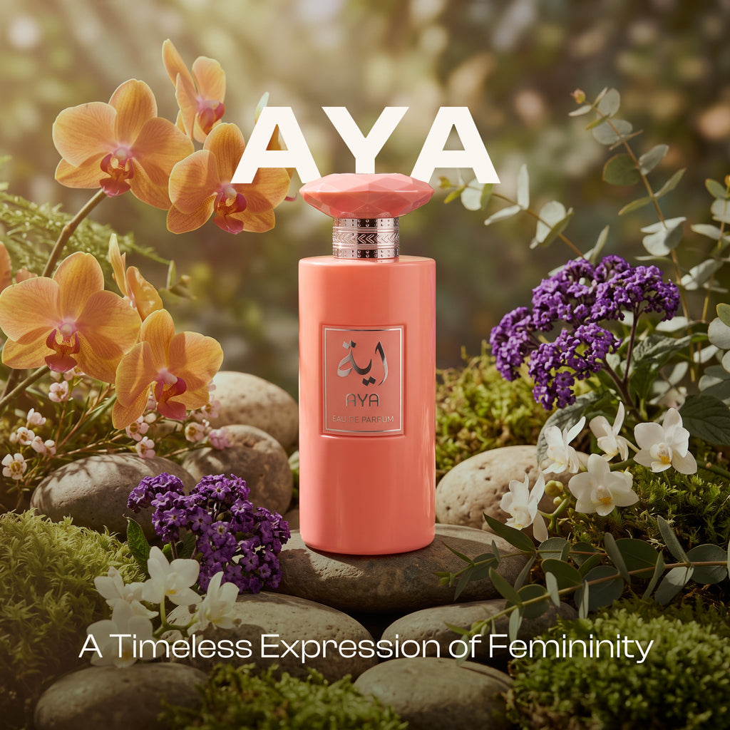 AYA Eau de Parfum pink bottle set on smooth stones surrounded by vibrant orange orchids, white blossoms, and purple flowers in a lush garden setting, with white overlay text reading "AYA" and "A Timeless Expression of Femininity".