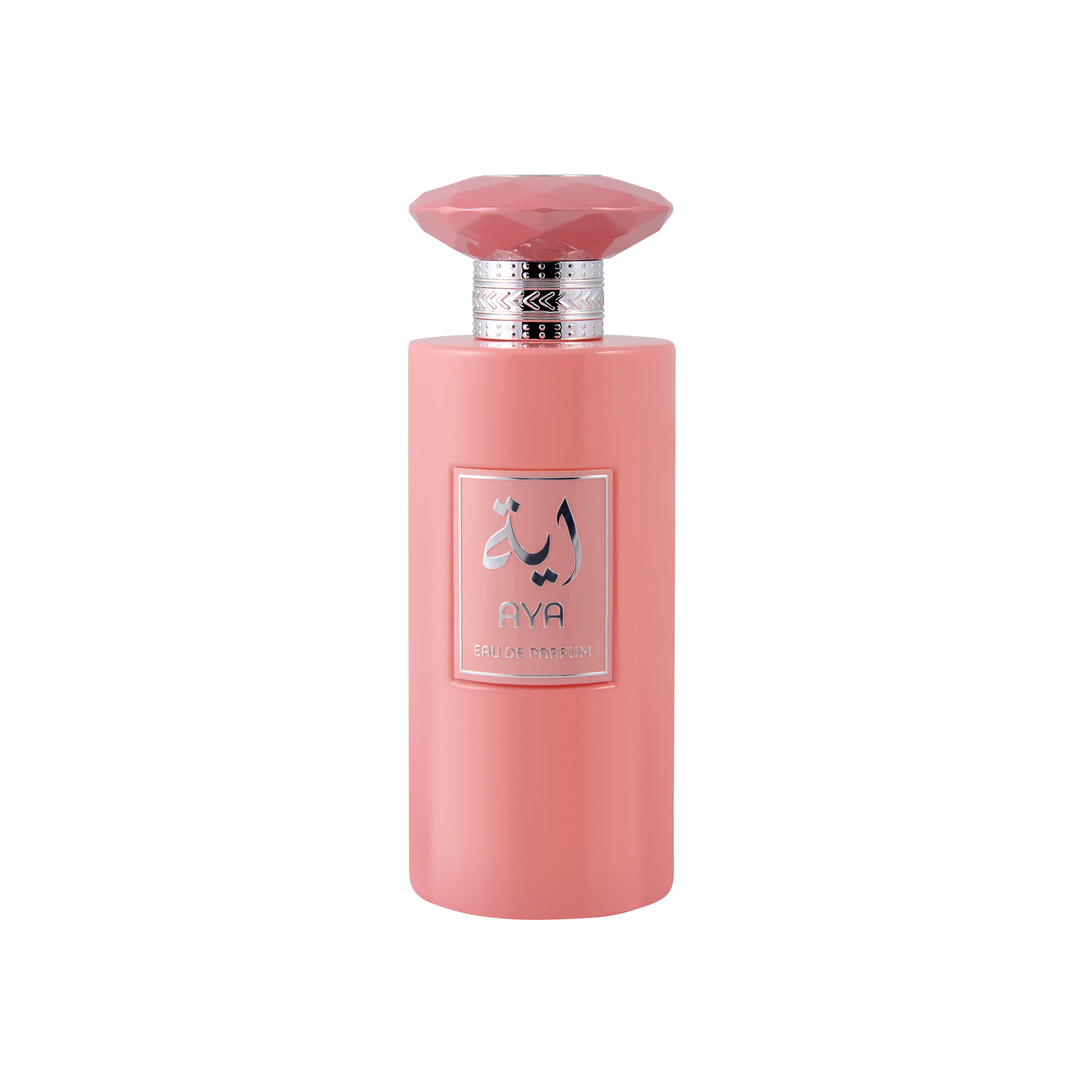 AYA Eau de Parfum cylindrical coral pink opaque bottle topped with a matching faceted gem-shaped cap and ornate silver collar, featuring a square silver label with Arabic calligraphy.