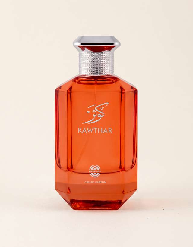 KAWTHAR Eau de Parfum by MUSHMUSH, an affordable luxury perfume for women , featuring an amber-orange translucent bottle with silver metallic cap and branding.