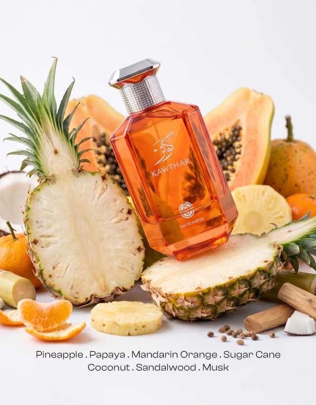 KAWTHAR Eau de Parfum by MUSHMUSH, an affordable luxury tropical fruity perfume , featuring an orange bottle surrounded by sliced pineapple, papaya, and mandarin orange.