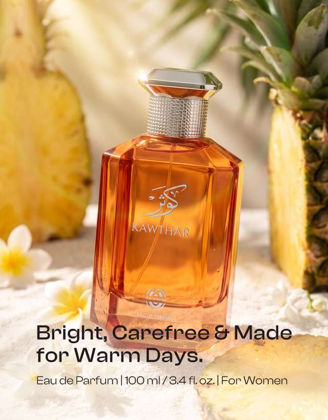 KAWTHAR Eau de Parfum by MUSHMUSH, an affordable luxury summer perfume, featuring an orange bottle set among pineapples and white flowers.