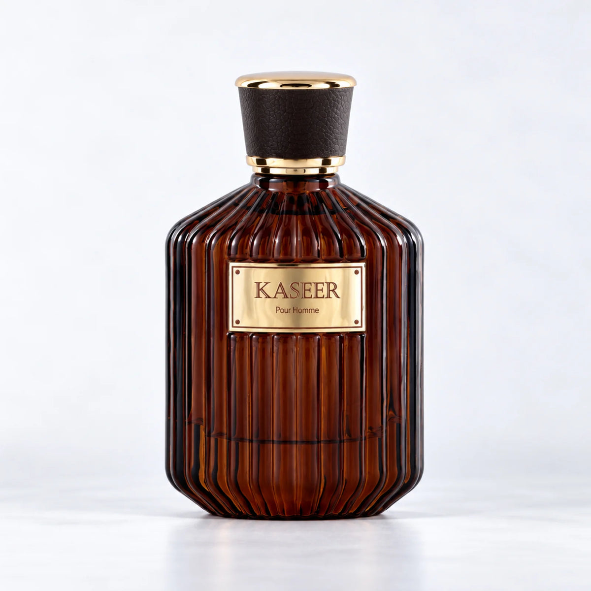 Kaseer Pour Homme ribbed dark amber perfume bottle with a black and gold cap by MUSHMUSH