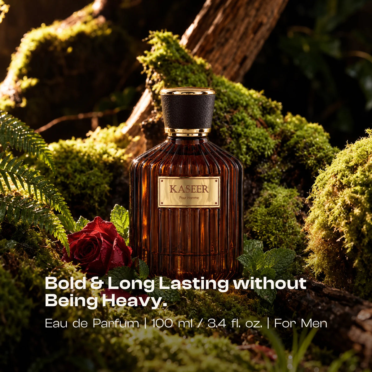 Kaseer Pour Homme amber bottle among moss, ferns and a red rose