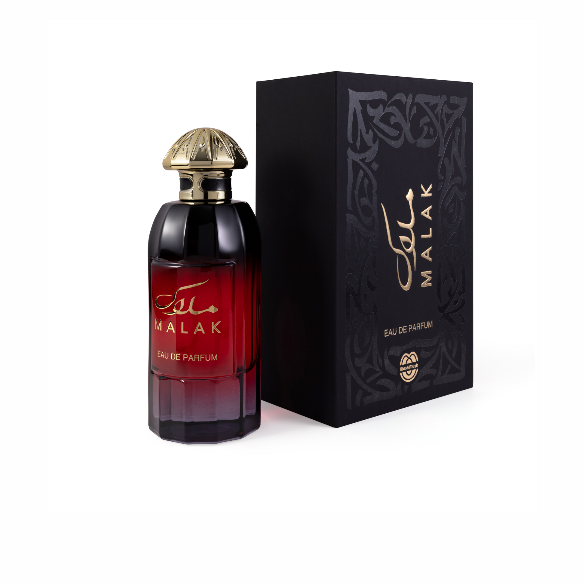 MALAK Eau de Parfum deep red gradient glass bottle topped with a carved gold dome cap, standing next to its black presentation box decorated with subtle black filigree patterns and gold lettering.