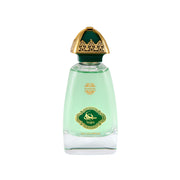 NAJM Eau de Parfum clear glass bottle filled with light mint green liquid, featuring an emerald green oval crest with gold filigree bordering and Arabic calligraphy, topped with an ornate gold and dark green dome cap.