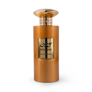 NOORAIN Eau de Parfum cylindrical metallic copper-orange bottle topped with a faceted diamond-shaped gold cap, featuring a gold plaque with Arabic typography.