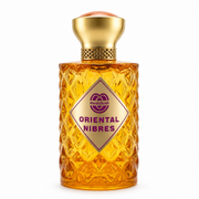 ORIENTAL NIBRES Eau de Parfum diamond-textured golden amber glass bottle topped with a metallic gold cap and peach crown accent, featuring a gold diamond-shaped front label with purple typography.