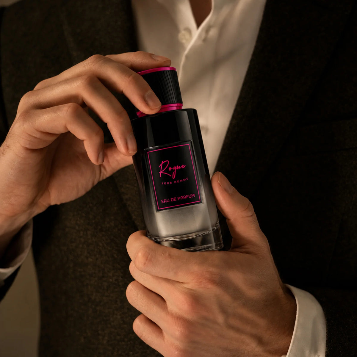 ROGUE for men and women perfume being sprayed onto a wrist