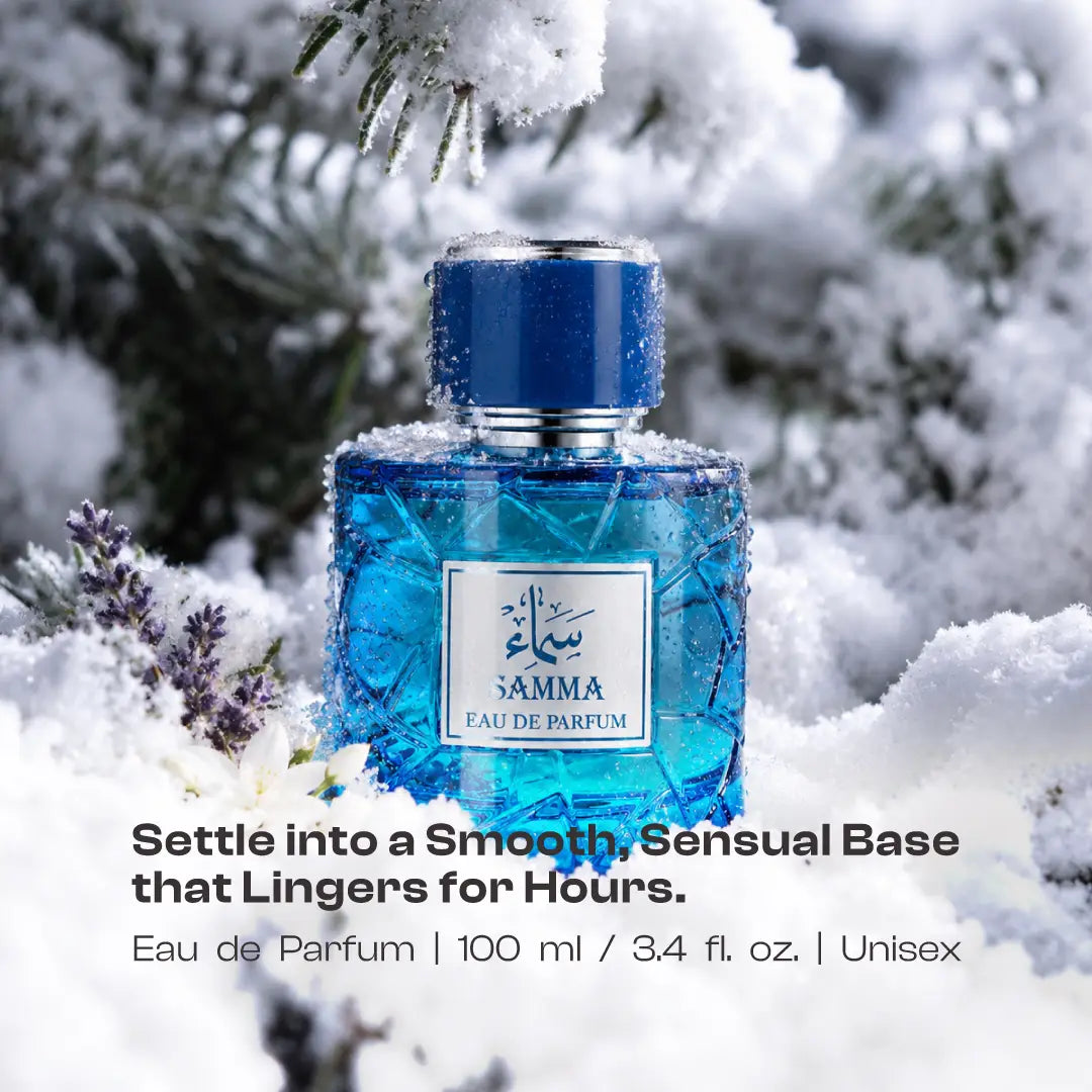 Samma perfume bottle dusted with snow beside lavender under a pine branch