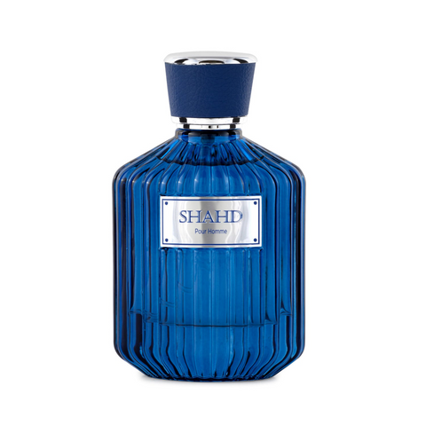 SHAHD Pour Homme Eau de Parfum ribbed deep cobalt blue glass bottle topped with a textured navy cap with silver trim, featuring a silver rectangular front plaque.