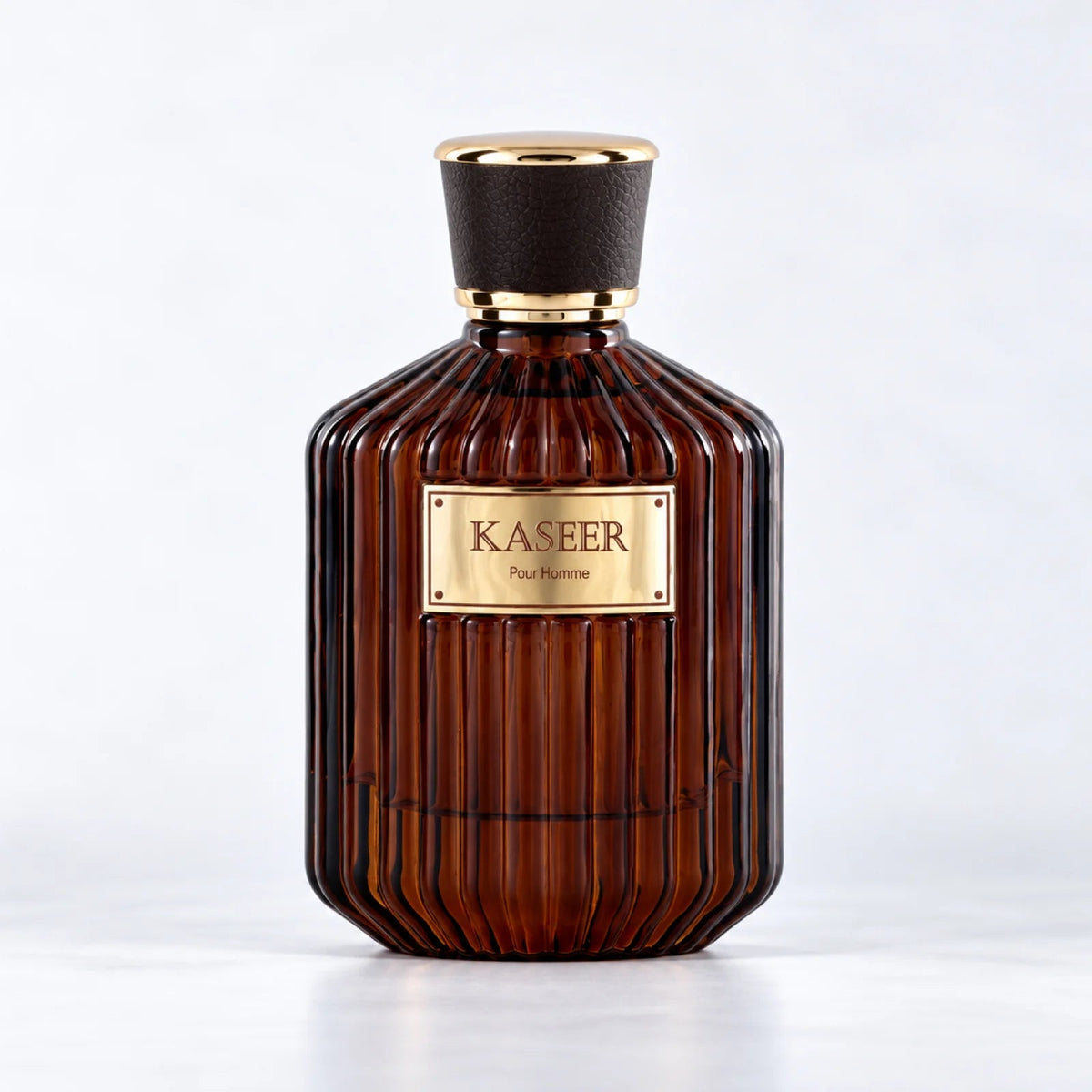 Kaseer Pour Homme ribbed dark amber perfume bottle with a black and gold cap by MUSHMUSH
